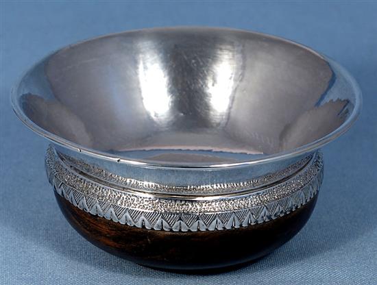 A George V Arts & Crafts planished silver mounted oak mazer, by Albert Edward Jones, Diameter 142mm height 2 ¾”/67mm